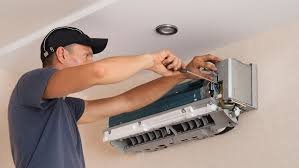 Technician repairing a commercial mini split system